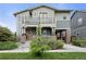 Inviting two-story home featuring a spacious porch, balcony, and a well-maintained landscaped front yard at 8464 E 55Th Pl, Denver, CO 80238