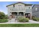 Inviting two-story home featuring a spacious porch, balcony, and a well-maintained landscaped front yard at 8464 E 55Th Pl, Denver, CO 80238