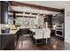 Modern kitchen with dark cabinetry, a central island, granite countertops, and stainless steel appliances at 8464 E 55Th Pl, Denver, CO 80238