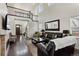 Open-concept living room featuring high ceilings, a stone fireplace, and dark hardwood floors at 8464 E 55Th Pl, Denver, CO 80238