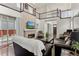 Bright living room featuring high ceilings, a stone fireplace, dark floors, and an open floorplan at 8464 E 55Th Pl, Denver, CO 80238