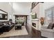 Spacious living room with a fireplace, high ceilings, dark wood floors and an open layout at 8464 E 55Th Pl, Denver, CO 80238