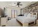 Spacious main bedroom with a decorative stone wall and a door to a small balcony at 8464 E 55Th Pl, Denver, CO 80238