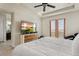 A modern main bedroom features a TV on top of the dresser and a door to a small balcony at 8464 E 55Th Pl, Denver, CO 80238