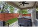 Covered patio featuring a relaxing hot tub, ceiling fan, and seating area for outdoor enjoyment at 8464 E 55Th Pl, Denver, CO 80238