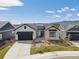Beautiful home featuring a modern exterior design and well-kept front yard at 6586 S Lewis Ct, Littleton, CO 80127