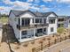 Stunning two-story modern farmhouse featuring a large deck, lower patio, and beautiful landscaping at 6586 S Lewis Ct, Littleton, CO 80127