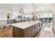 Bright open kitchen with large island, modern appliances, and adjacent dining area at 6586 S Lewis Ct, Littleton, CO 80127