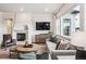 Cozy living room with fireplace, elegant furniture, and lots of natural light at 6586 S Lewis Ct, Littleton, CO 80127