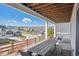 Enjoy outdoor dining with a view on this covered patio featuring a picnic table and a porch swing at 6586 S Lewis Ct, Littleton, CO 80127