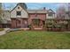 Expansive backyard featuring a lush lawn, pergola, brick patio and sports court at 239 Ash St, Denver, CO 80220