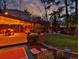 Inviting covered patio with string lights, comfortable seating, and lush landscaping creating an outdoor oasis at 239 Ash St, Denver, CO 80220