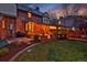 Charming backyard featuring a covered patio, green grass, basketball hoop and brick walkway at 239 Ash St, Denver, CO 80220