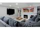 Finished basement with a comfortable sectional sofa, large screen television, and decorative fireplace at 239 Ash St, Denver, CO 80220