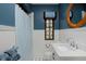 Charming bathroom featuring wainscoting, a pedestal sink, black and white tile flooring, and a window at 239 Ash St, Denver, CO 80220