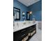 Bathroom features dual sinks with marble countertops and stylish blue walls at 239 Ash St, Denver, CO 80220