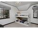 Charming bedroom featuring a bunk bed, gray window treatments, and a modern light fixture at 239 Ash St, Denver, CO 80220