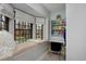 Cozy bedroom with window seat, natural light, built-in shelving, and a compact desk area at 239 Ash St, Denver, CO 80220