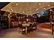 Cozy covered patio with outdoor dining and seating, string lights, and colorful garden views at 239 Ash St, Denver, CO 80220