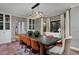 Elegant dining room with a modern chandelier, textured walls, and a large table with orange chairs at 239 Ash St, Denver, CO 80220