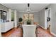 Tastefully decorated dining room with textured wallpaper, stylish accents, and a view into the kitchen at 239 Ash St, Denver, CO 80220