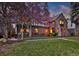 Beautiful brick home with inviting curb appeal and mature landscaping at dusk at 239 Ash St, Denver, CO 80220