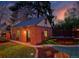 Charming brick garage with a well-maintained lawn, garden beds, and recreational trampoline at 239 Ash St, Denver, CO 80220
