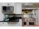 Modern kitchen with stainless steel appliances, granite countertops, and white cabinets at 239 Ash St, Denver, CO 80220