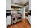 Well-equipped kitchen with a Wolf range, stainless steel hood, and access to the dining room at 239 Ash St, Denver, CO 80220