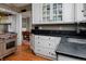 Modern kitchen featuring stainless steel appliances, dark countertops, and view to the dining area at 239 Ash St, Denver, CO 80220