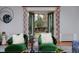 Bright living room with green chairs, stylish mirror, and French doors overlooking the landscaped backyard at 239 Ash St, Denver, CO 80220