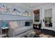 Comfortable gray couch in Gathering room with stylish accents and natural light at 239 Ash St, Denver, CO 80220