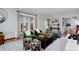 Inviting living room with hardwood floors, colorful accents, and French doors to the backyard at 239 Ash St, Denver, CO 80220
