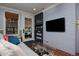 Comfortable gray couch in living room with stylish brick wall and natural light at 239 Ash St, Denver, CO 80220