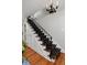 Staircase design boasts hardwood steps, a patterned runner, and stylish black chandelier at 239 Ash St, Denver, CO 80220