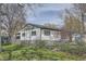 Exterior view of house with a chain link fence and a large backyard featuring plenty of space at 925 Quitman St, Denver, CO 80204