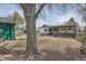 Exterior view of the residence backyard, featuring a large tree and partial fence at 925 Quitman St, Denver, CO 80204