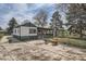 This image showcases the backyard featuring a concrete patio, partial fencing, and storage at 925 Quitman St, Denver, CO 80204