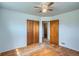 Comfortable bedroom with hardwood floors, closet, and a ceiling fan at 925 Quitman St, Denver, CO 80204