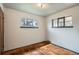 Bright bedroom featuring hardwood floors and two windows at 925 Quitman St, Denver, CO 80204