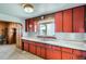 The kitchen is equipped with bright red cabinets, a sink, and lots of counter space at 925 Quitman St, Denver, CO 80204