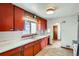 Clean kitchen featuring bright red cabinets, white countertops, and vinyl flooring at 925 Quitman St, Denver, CO 80204