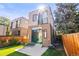 Exterior rear view of a two-story home featuring a patio with outdoor seating at 1833 E Jewell Ave, Denver, CO 80210