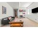 Finished basement offering a comfortable living area with a media setup, ideal for relaxation and entertainment at 1833 E Jewell Ave, Denver, CO 80210