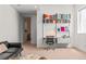 Versatile basement space that includes a sofa, an office area, and access to additional rooms within the home at 1833 E Jewell Ave, Denver, CO 80210