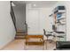 Finished basement area featuring a modern desk, work area, and staircase at 1833 E Jewell Ave, Denver, CO 80210