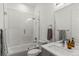 Modern bathroom featuring tile surround tub and shower combo and contemporary vanity at 1833 E Jewell Ave, Denver, CO 80210