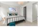 Cozy bedroom with modern lighting, plush carpet, and a view of the neighborhood at 1833 E Jewell Ave, Denver, CO 80210