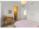 Cozy bedroom featuring a desk, a pink gingham bedspread, and an ensuite bathroom for added convenience at 1833 E Jewell Ave, Denver, CO 80210