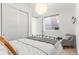 Inviting bedroom featuring a comfortable bed, accent chair, ample closet space, and natural light at 1833 E Jewell Ave, Denver, CO 80210
